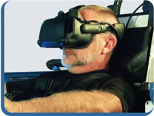 A man wearing a VR headset sitting inside of the platform